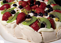 pavlova dessert filled with fruit and cream