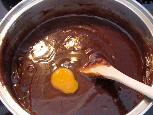 adding an egg to cake batter