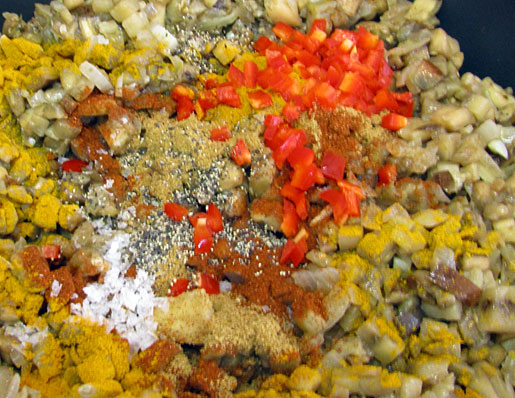 adding chilli, paprika, cumin and turmeric into eggplant jam
