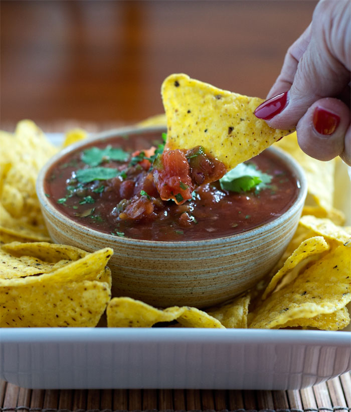 Easy homemade salsa from canned tomatoes. Takes less than 15 minutes and tastes like what you get at Mexican restaurants. The real deal!