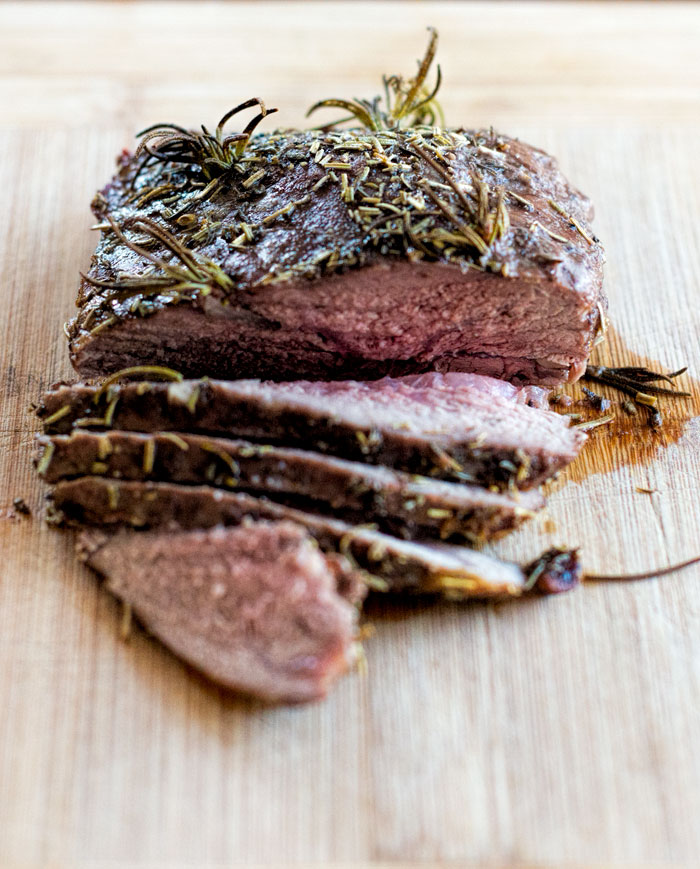 Lamb sirloin roast on a cutting board.